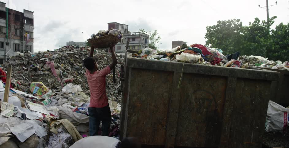 People going through rubbish in a landfill