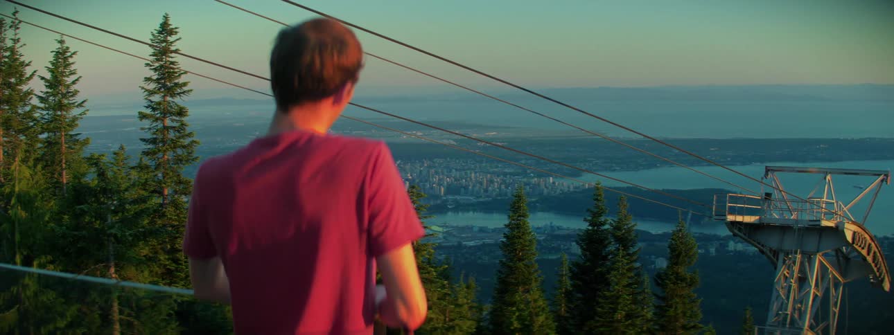A man stands in front of a ski lift