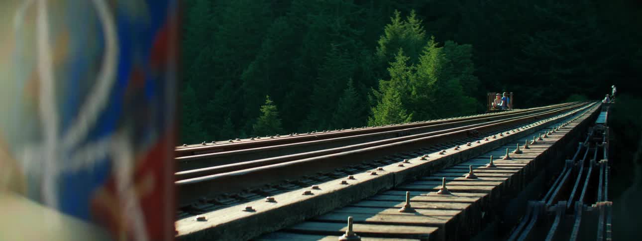 People on pedal cart on railroad bridge