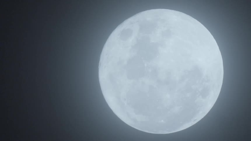 Full moon brightly shines in the sky at night