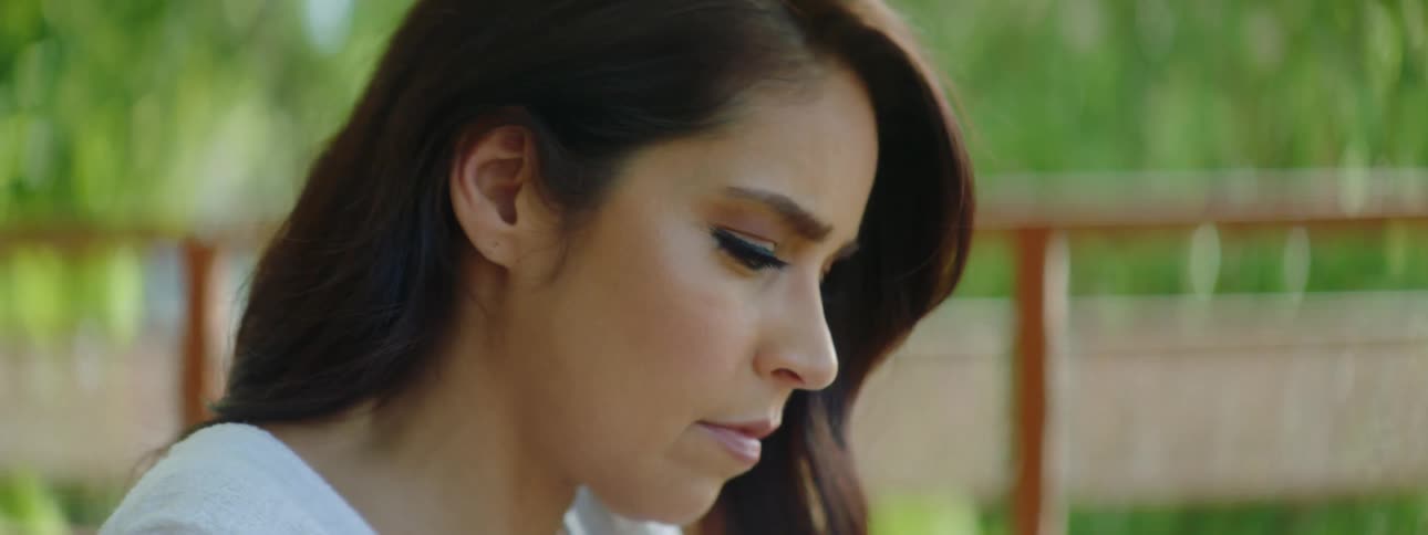 A woman is looking at her cellphone outdoors in spring