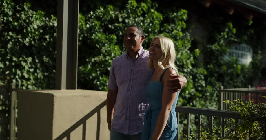 A man and a woman talking hugging and walking while holding hands