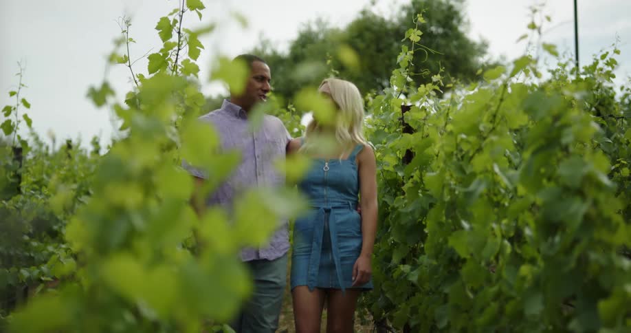 A man and woman are walking outdoors together