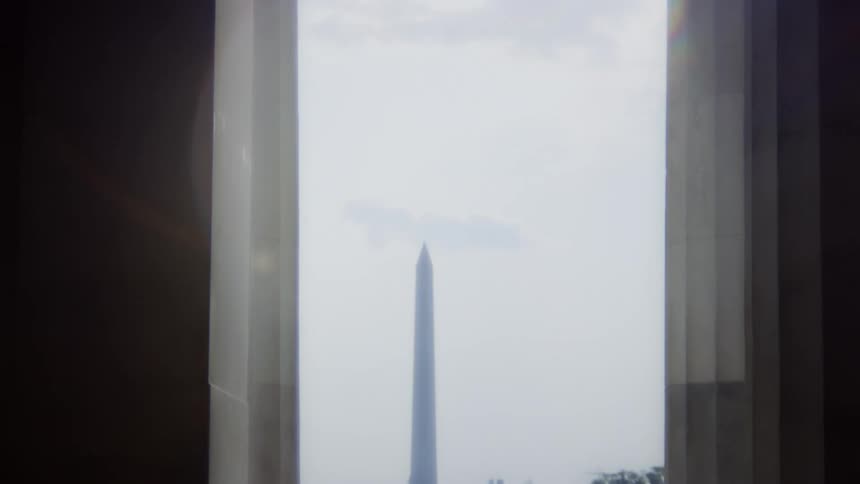 Sun glares through opening that allows view of the washington monument