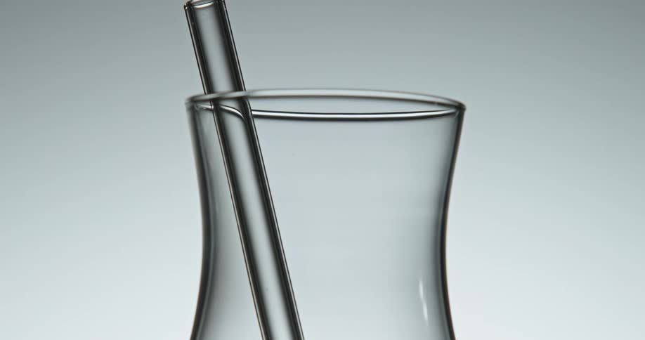 A glass jug with a mixer with light and reflection