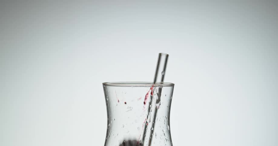 Raspberries drop into a glass