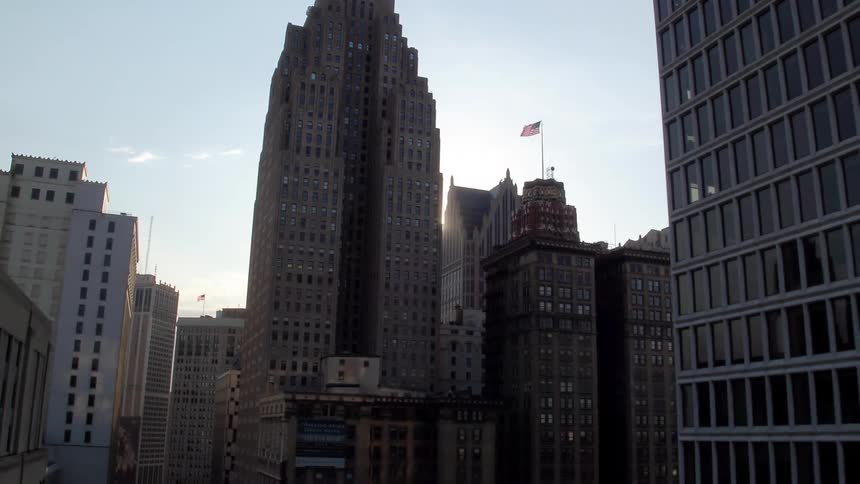 The sun shines between skyscrapers in a metropolis on a sunny day