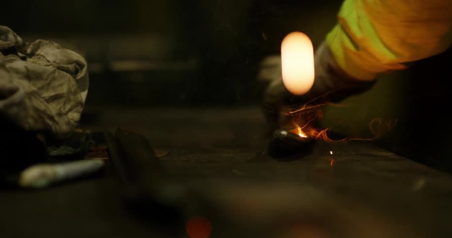 A welder uses a torch on a beam