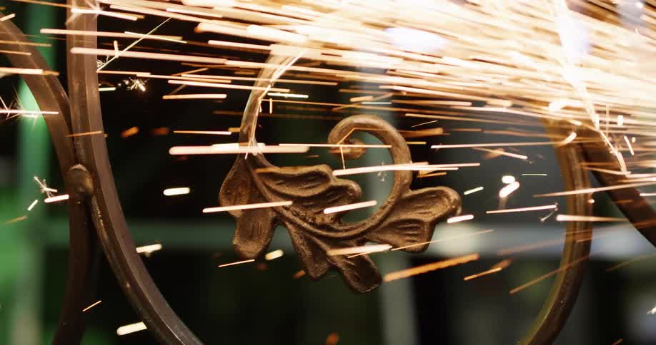 A close view of sparks flying from grinding on metal in a workshop