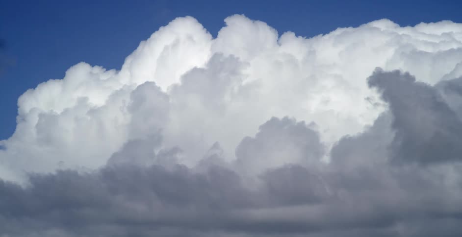 A sky with clouds and sunlight with light and shadow