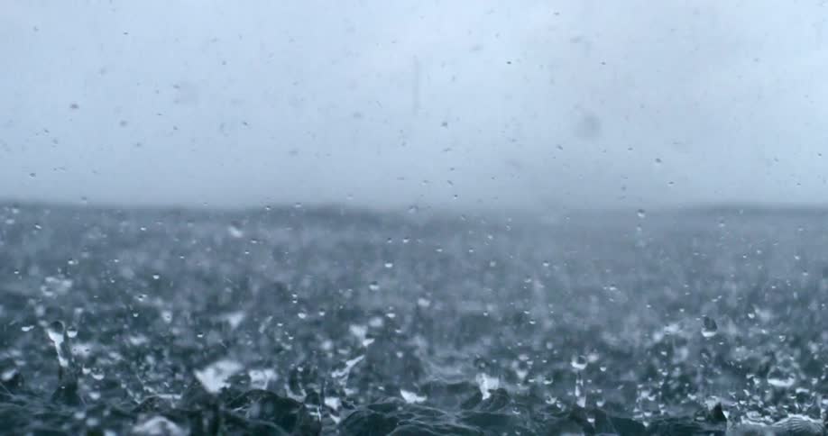 Heavy rain pours on the water