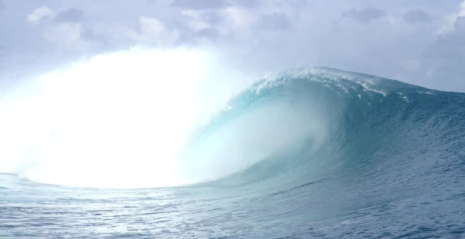 The large wave crashes in the ocean