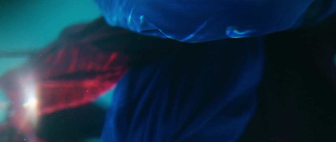Red and blue cloth underwater with light and bubbles