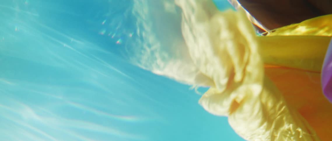 Yellow and pink fabric floating underwater