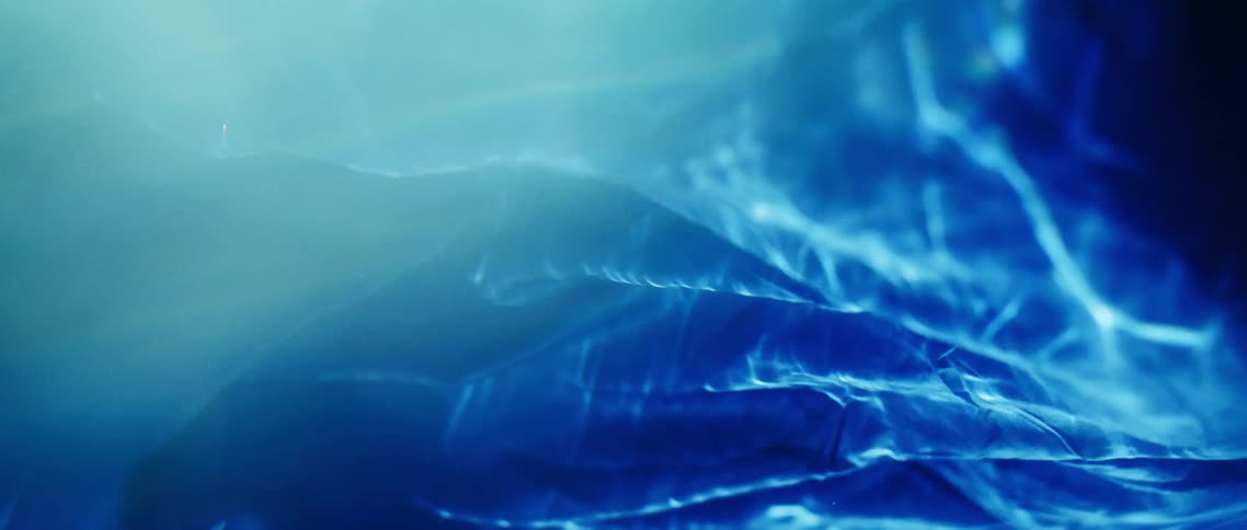 Blue cloth underwater with light and bubbles