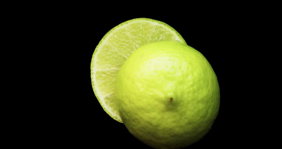 A knife cutting through a lime with light and reflection