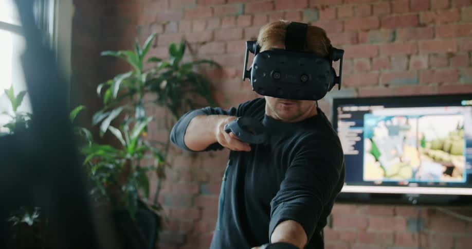 A man playing a virtual reality game at home