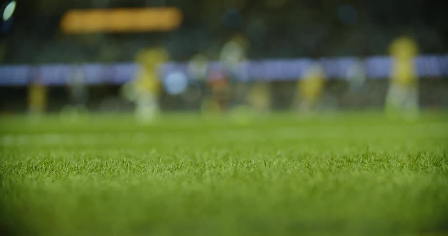 Players playing soccer on a grassy field