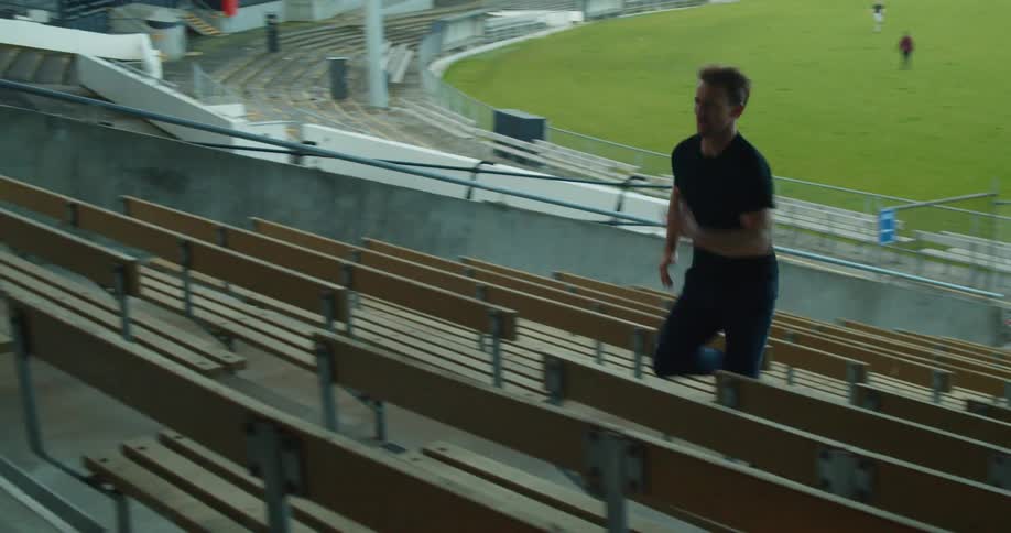 A man running up stairs in a stadium