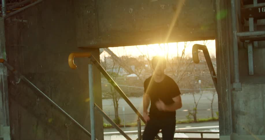 A man exercising runs up stairs in a stadium