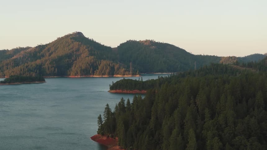 Large lake between pine covered mountains and islands