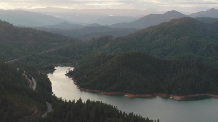 An aerial view of a river flowing through a forest