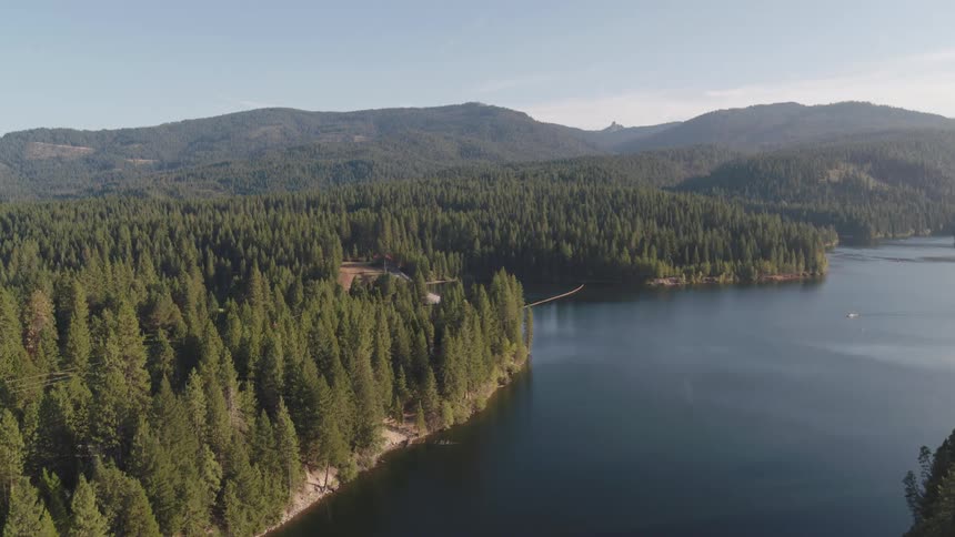 An aerial view of a lake off a forest area