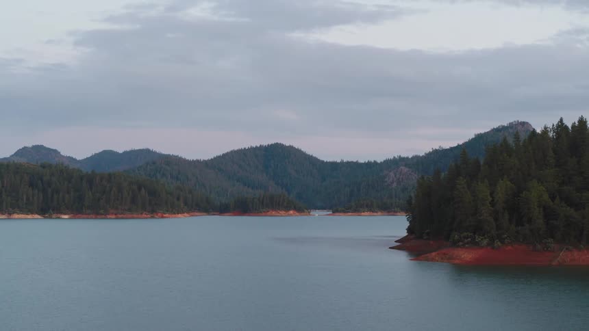 Large lake with islands in front of mountain range