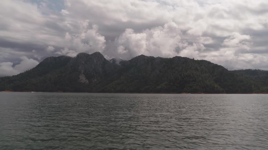 Waves are moving towards the mountain coast