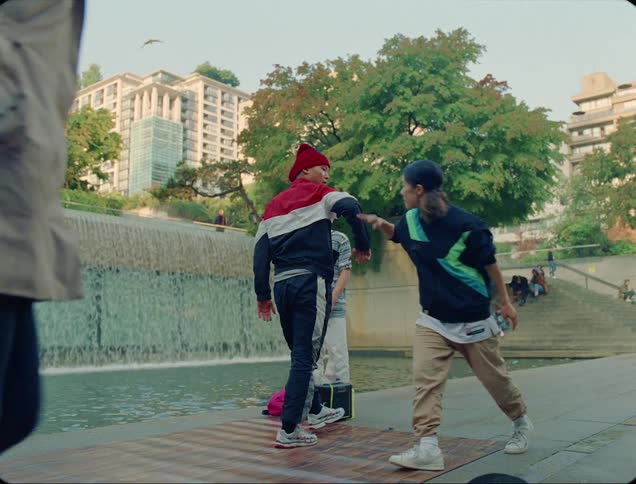 Young people hip hop dancing in public park