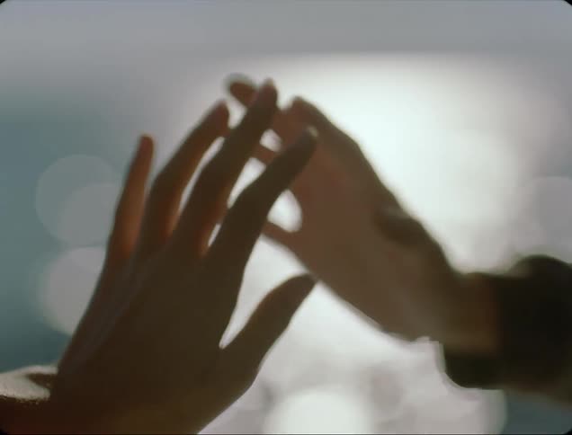 Two people are holding hands outdoors