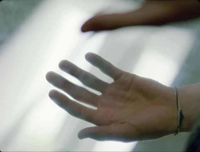 A person is placing their hand on the mirror