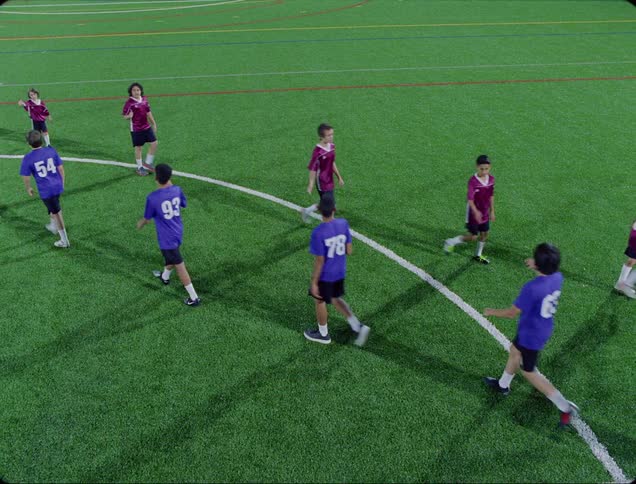 Two childrens soccer teams greet one another before a game