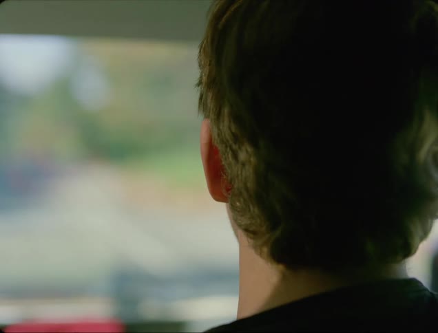 A man is riding in a car