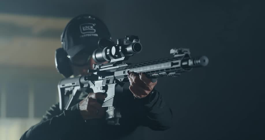 A woman shooting a rifle indoors