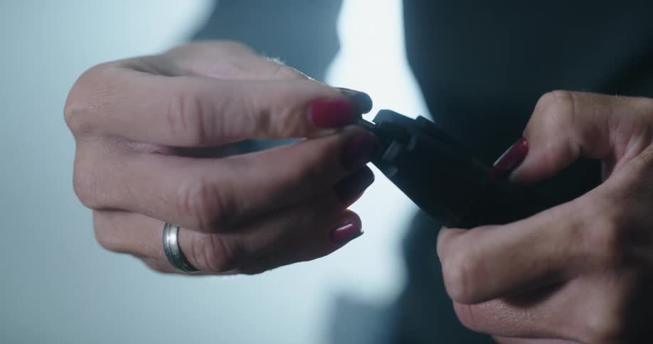 A woman loads bullets in to a carriage for a gun
