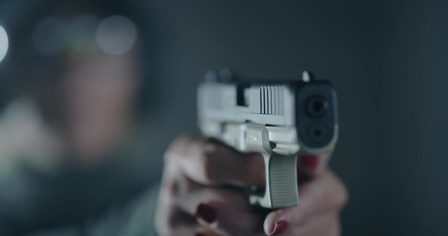 A female pointing a firearm