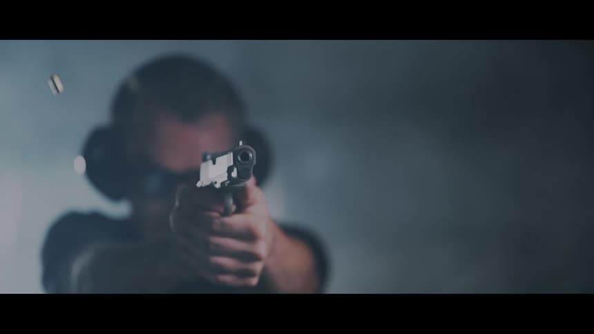A white man fires a handgun
