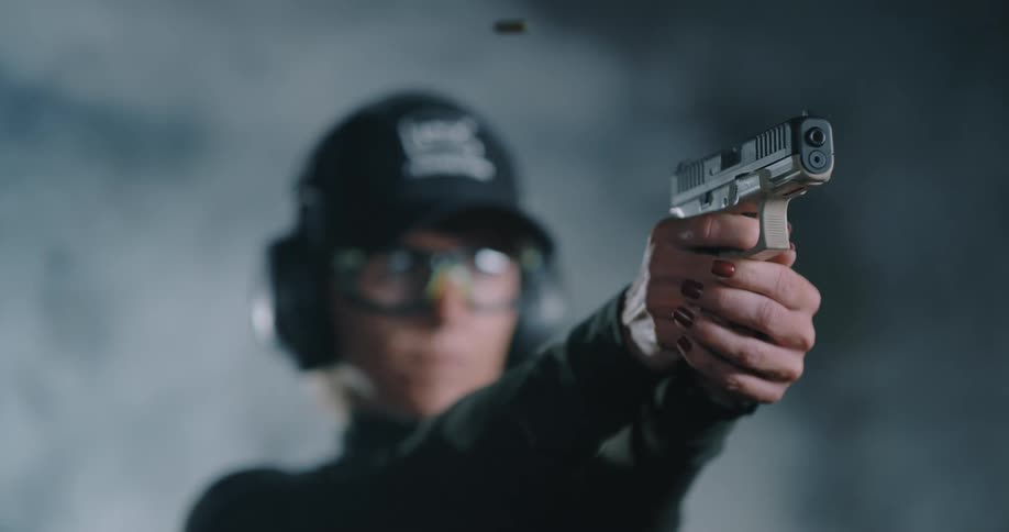 A white woman fires a gun