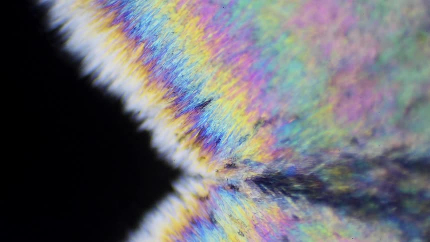 Colorful crystals grow under a microscope