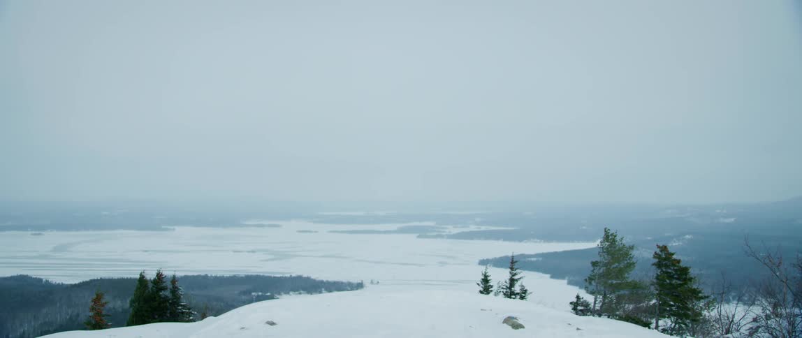 A winter storm approaches a snow covered wilderness