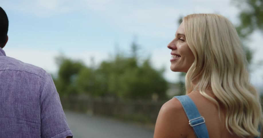 A man and woman walking down a sidewalk together