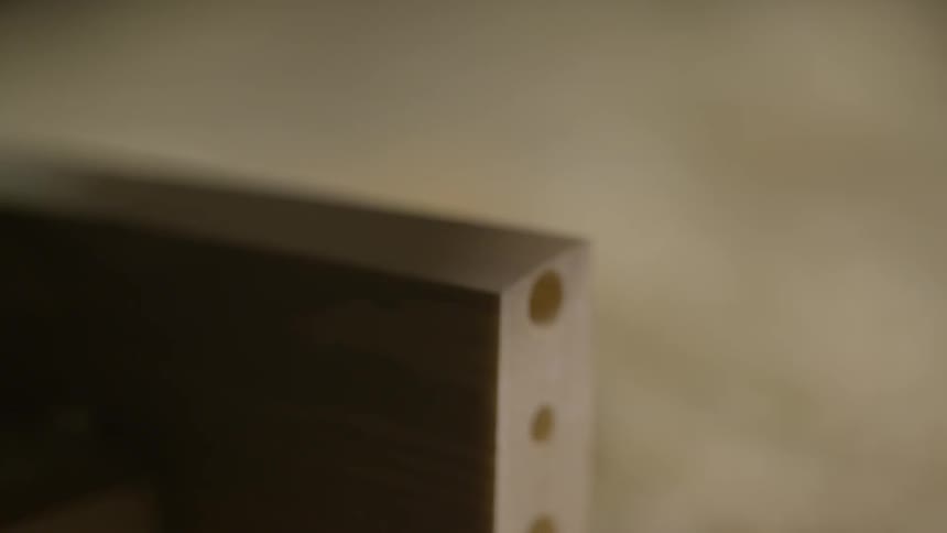 Close up of a tool shaving a piece of wood