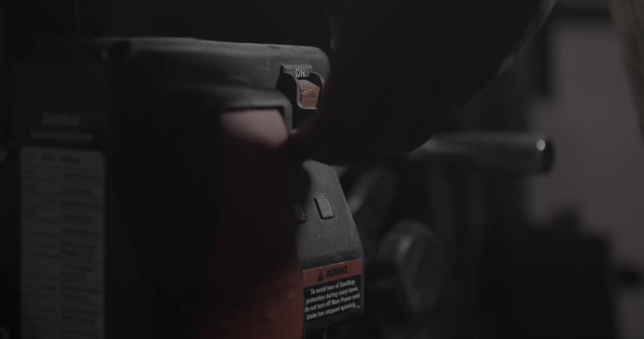 A person turns a switch on a machine