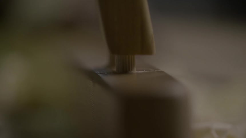 A piece of wood is placed on a peg
