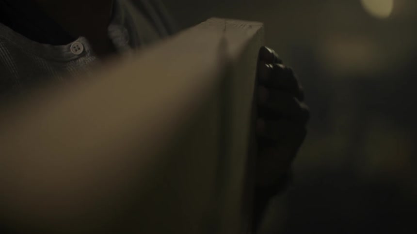 A person inspects a board