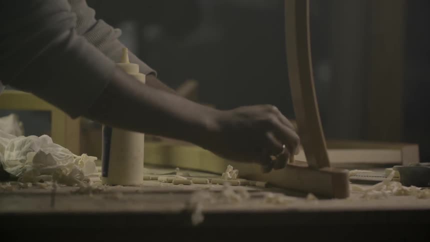 A person is building a chair on a table