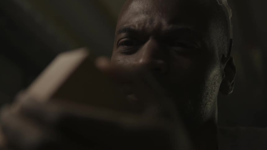A man looking closely at a piece of wood