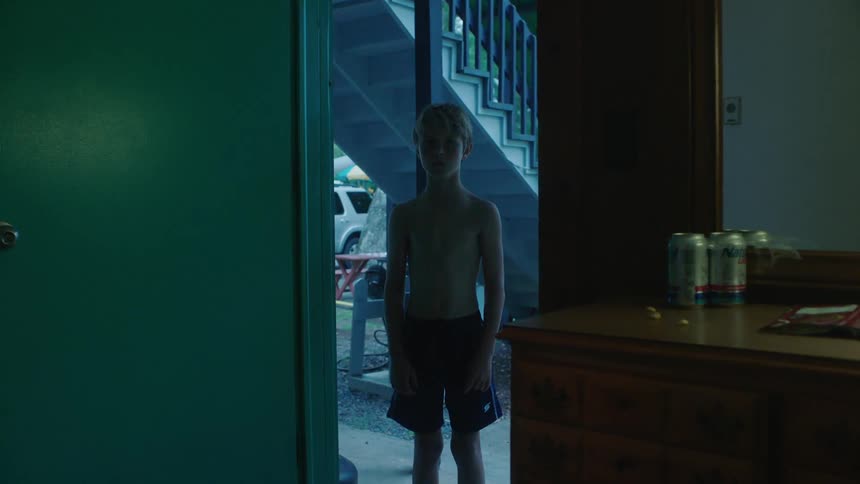 Sirens shine on a boy in the doorway