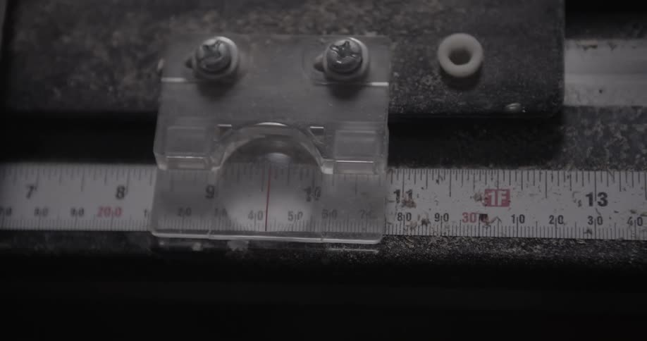A machine skims over a tape measure